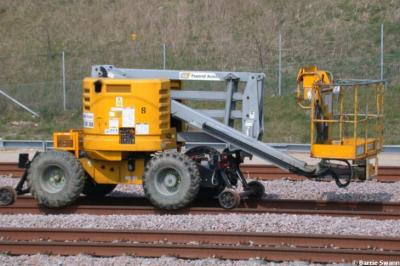 image showing a large yellow on-track machine