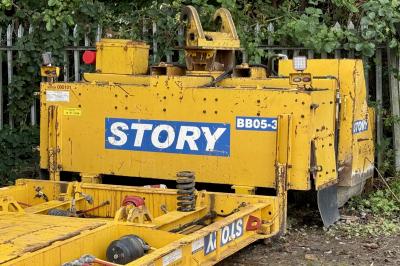 image showing a large yellow on-track machine