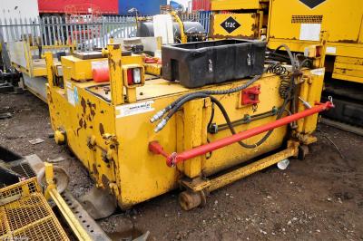 image showing a large yellow on-track machine